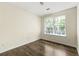 Bright bedroom with wood flooring and a window overlooking a green landscape at 7331 Wagon Wheel Ct, Jonesboro, GA 30236