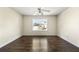 Bedroom featuring hardwood floors, a ceiling fan, and a bright window at 7331 Wagon Wheel Ct, Jonesboro, GA 30236