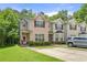 Two-story townhome featuring well-maintained lawn and convenient parking at 7331 Wagon Wheel Ct, Jonesboro, GA 30236