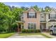 Charming townhome with lush green landscaping and a private parking area at 7331 Wagon Wheel Ct, Jonesboro, GA 30236