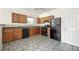 Efficient kitchen with ample cabinets, black appliances, and tile floor at 7331 Wagon Wheel Ct, Jonesboro, GA 30236