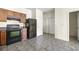 Functional kitchen with dark appliances, wood cabinets, and tiled floor at 7331 Wagon Wheel Ct, Jonesboro, GA 30236