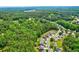 Aerial view of a neighborhood surrounded by dense trees and foliage at 133 Parkway Dr, Fairburn, GA 30213