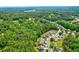 A serene aerial view showcases a neighborhood near lush greenery and wooded areas at 133 Parkway Dr, Fairburn, GA 30213