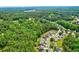 Aerial view of a neighborhood nestled among lush greenery and trees at 133 Parkway Dr, Fairburn, GA 30213