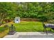 Expansive backyard featuring a storage shed, fire pit, and well-maintained lawn at 133 Parkway Dr, Fairburn, GA 30213