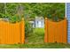 Inviting backyard featuring a storage shed behind a decorative gate at 133 Parkway Dr, Fairburn, GA 30213