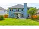 Expansive backyard with a well-maintained lawn, patio area, and privacy fence at 133 Parkway Dr, Fairburn, GA 30213