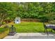 Spacious backyard featuring lush greenery, a shed, and a grill, perfect for outdoor activities and entertaining at 133 Parkway Dr, Fairburn, GA 30213