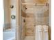 Shower with glass door and tiled walls, accented with decorative metal wall art at 133 Parkway Dr, Fairburn, GA 30213