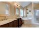 Well-lit bathroom with double sinks, soaking tub and glass shower at 133 Parkway Dr, Fairburn, GA 30213
