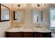 Bathroom featuring double sinks with modern fixtures and large, decorative mirrors at 133 Parkway Dr, Fairburn, GA 30213