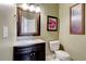 Stylish half-bath with dark wood vanity, granite countertop, and decorative accents, providing convenience for guests at 133 Parkway Dr, Fairburn, GA 30213
