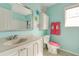 Bright bathroom featuring turquoise walls, playful decor, and a vanity at 133 Parkway Dr, Fairburn, GA 30213