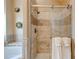 Bathroom featuring tiled shower with glass door, decorative shower head, and tiled accent border at 133 Parkway Dr, Fairburn, GA 30213