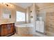 Bathroom featuring a soaking tub, glass shower, and custom vanity at 133 Parkway Dr, Fairburn, GA 30213