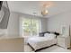 Light-filled bedroom with modern decor, plush rug, and window with outdoor view at 133 Parkway Dr, Fairburn, GA 30213