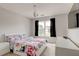 Bright bedroom with floral bedding, modern furniture, and a window view at 133 Parkway Dr, Fairburn, GA 30213