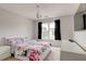 Bright bedroom with white furniture, floral bedding, and natural light at 133 Parkway Dr, Fairburn, GA 30213