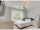 Bright bedroom features a large window, chandelier, and neutral decor at 133 Parkway Dr, Fairburn, GA 30213
