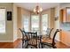 Bright breakfast nook features a round glass table and three large windows at 133 Parkway Dr, Fairburn, GA 30213