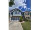 Charming two-story home with a brick and siding facade, blue accents, and well-manicured lawn at 133 Parkway Dr, Fairburn, GA 30213