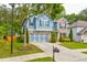Charming two-story home boasts a well-manicured lawn, blue siding, and a two-car garage at 133 Parkway Dr, Fairburn, GA 30213