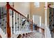Grand foyer featuring a staircase with wood railing and carpet runner leading to a bright entry with a chandelier and front door at 133 Parkway Dr, Fairburn, GA 30213