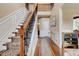 Elegant foyer featuring hardwood floors, a staircase with an ornate railing, and wainscoting at 133 Parkway Dr, Fairburn, GA 30213