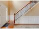 Welcoming foyer featuring hardwood floors, a classic staircase, and elegant wainscoting, creating a warm ambiance at 133 Parkway Dr, Fairburn, GA 30213