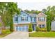 Charming two-story home with a blue exterior, brick accents, and a well-manicured front yard at 133 Parkway Dr, Fairburn, GA 30213