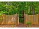 Gated entrance leads to a home with a charming treehouse at 133 Parkway Dr, Fairburn, GA 30213