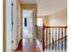 Upstairs hallway with hardwood flooring near closets and a bedroom at 133 Parkway Dr, Fairburn, GA 30213