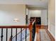 Hallway features wood floors, wood and iron banister, and laundry closet at 133 Parkway Dr, Fairburn, GA 30213