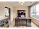 Bright home office with dark wood furniture, a large window, and neutral wall colors at 133 Parkway Dr, Fairburn, GA 30213