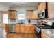 Bright kitchen with stainless steel appliances, granite countertops, and wood cabinets, ideal for cooking and entertaining at 133 Parkway Dr, Fairburn, GA 30213