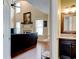 Bright living room adjoining a half-bath featuring hardwood floors, a fireplace, and high ceilings providing space for everyday living at 133 Parkway Dr, Fairburn, GA 30213