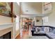 Open-concept living room with fireplace, hardwood floors, and view of the kitchen at 133 Parkway Dr, Fairburn, GA 30213