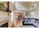 Open-concept living room with a fireplace, hardwood floors, and view of kitchen, creating a warm and inviting living space at 133 Parkway Dr, Fairburn, GA 30213