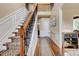 Elegant staircase features hardwood floors, a decorative runner, and wrought iron railings at 133 Parkway Dr, Fairburn, GA 30213