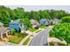 View of a street with several single Gathering homes, mature trees, and well-manicured lawns at 133 Parkway Dr, Fairburn, GA 30213
