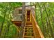 Unique treehouse accessible by wooden stairs provides a secluded spot for or a quiet retreat at 133 Parkway Dr, Fairburn, GA 30213