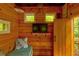 Cozy interior of the treehouse, featuring wood-paneled walls, TV, and small windows at 133 Parkway Dr, Fairburn, GA 30213
