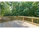 Wooden deck provides an ideal outdoor space for relaxation and entertaining, surrounded by lush trees at 2995 Aspen Ridge Ct, Snellville, GA 30078