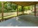 Back patio featuring a concrete ceiling and flooring, offering a versatile outdoor space with a backyard view at 2995 Aspen Ridge Ct, Snellville, GA 30078