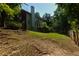 View of the home from the back yard, with a privacy fence, and mature trees at 2995 Aspen Ridge Ct, Snellville, GA 30078