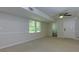 Basement area boasting a ceiling fan, neutral carpet and a bathroom and door adding convenience and privacy at 2995 Aspen Ridge Ct, Snellville, GA 30078