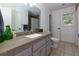 Bathroom featuring tiled floors, a granite countertop, and a window for natural light at 2995 Aspen Ridge Ct, Snellville, GA 30078