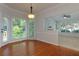 Dining area with wood floors and a view into the living room, providing a spacious and connected feel at 2995 Aspen Ridge Ct, Snellville, GA 30078