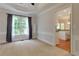 Bright living room with large windows, soft carpet, and elegant trim at 2995 Aspen Ridge Ct, Snellville, GA 30078